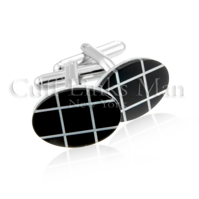 Oval Onyx and mother of pearl cuff links: flat and highly polished onyx is the centerpiece of these beautiful cuff links that are only enhanced by the rainbow-like properties of the carefully placed strips of mother of pearl.